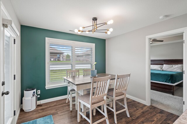 4841 Valley Forge Cir, Ashland, MO 65010 - dining space featuring a chandelier, dark wood-style floors, and baseboards