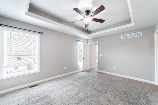 5506 Murfreesboro Dr, Columbia, MO 65201 - carpeted spare room with a raised ceiling, a ceiling fan, healthy amount of natural light, and baseboards