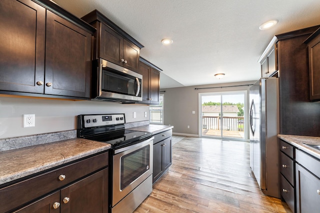 5506 Murfreesboro Dr, Columbia, MO 65201 - kitchen with stainless steel appliances, light wood-style flooring, dark brown cabinetry, baseboards, and recessed lighting