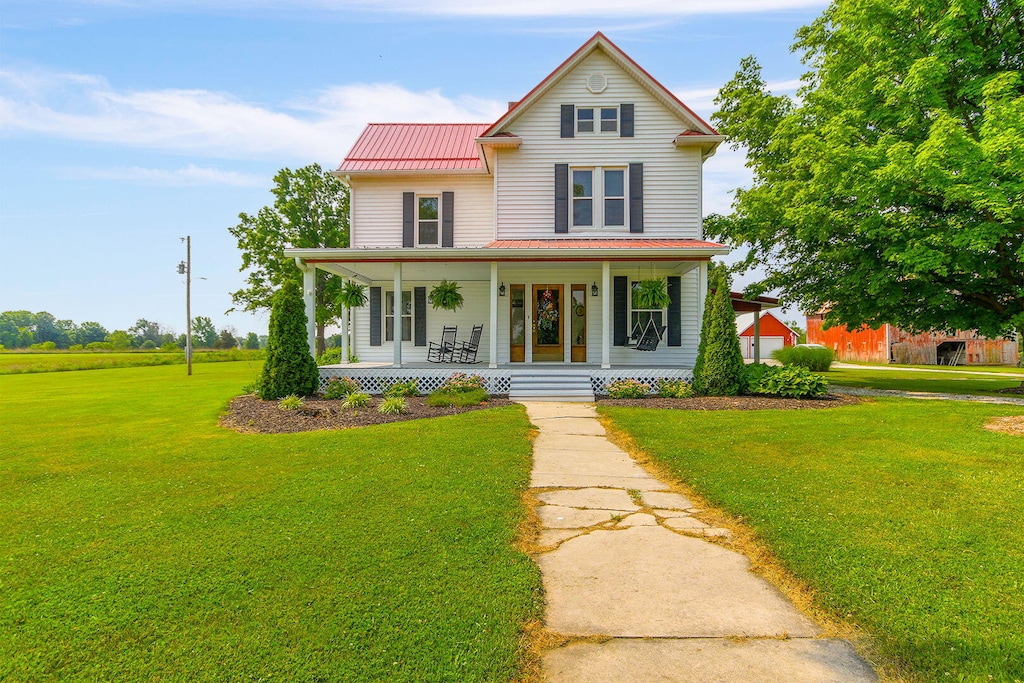 14535 Audrain Rd Unit 9815, Mexico, MO 65265 - view of front facade featuring covered porch, a front lawn, metal roof, and a standing seam roof