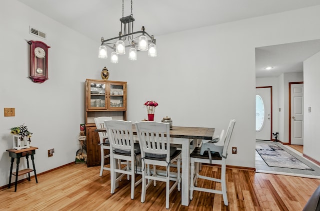 1402 Jean Rae Dr, Columbia, MO 65203 - dining room with light wood-style floors, baseboards, and a chandelier