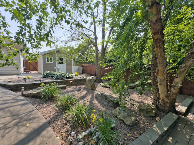 1402 Jean Rae Dr, Columbia, MO 65203 - fenced backyard featuring an outdoor structure and a patio area