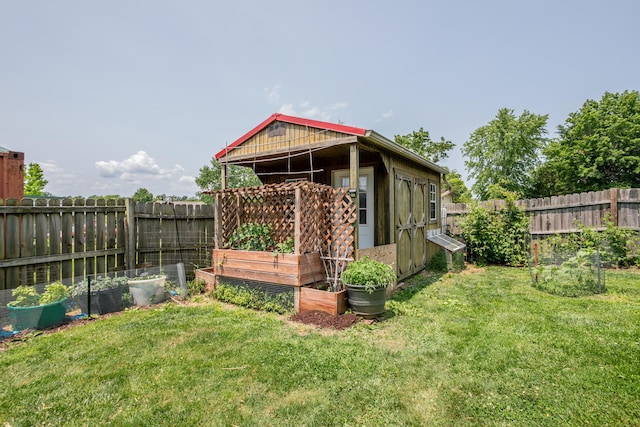 7901 N Chesley Dr, Columbia, MO 65202 - view of yard with a vegetable garden and an outbuilding