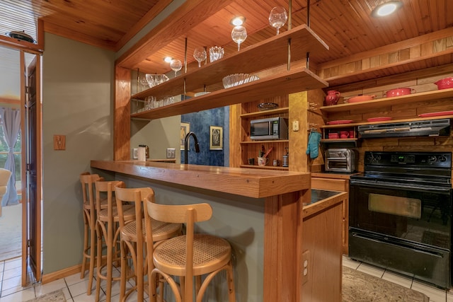 7901 N Chesley Dr, Columbia, MO 65202 - indoor wet bar featuring black / electric stove, range hood, light tile patterned flooring, stainless steel microwave, and wood ceiling