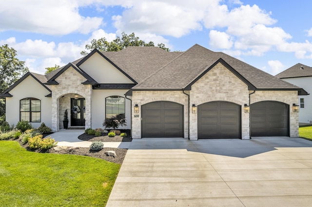 7501 Kirby Knowle Ct, Columbia, MO 65203 - french country style house featuring stone siding, roof with shingles, and concrete driveway