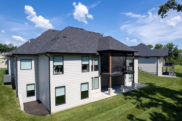 7501 Kirby Knowle Ct, Columbia, MO 65203 - back of house with a sunroom, a patio, a yard, and roof with shingles