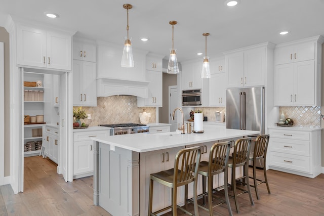 7501 Kirby Knowle Ct, Columbia, MO 65203 - kitchen featuring decorative backsplash, light countertops, appliances with stainless steel finishes, white cabinets, and recessed lighting
