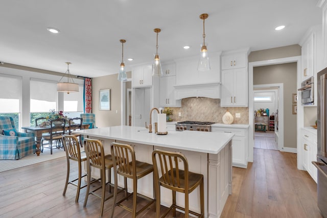 7501 Kirby Knowle Ct, Columbia, MO 65203 - kitchen featuring light countertops, decorative backsplash, healthy amount of natural light, white cabinets, and recessed lighting