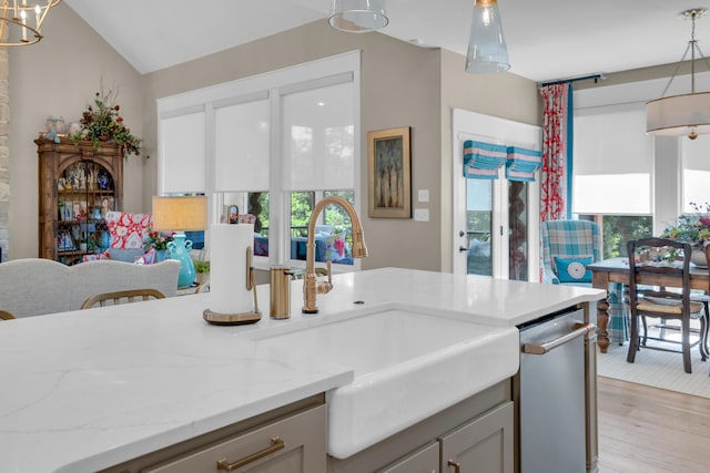 7501 Kirby Knowle Ct, Columbia, MO 65203 - kitchen featuring light wood-style floors, light stone counters, decorative light fixtures, open floor plan, and dishwasher