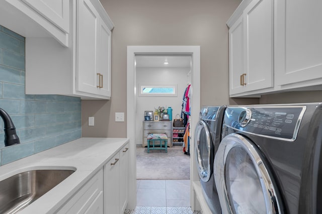 7501 Kirby Knowle Ct, Columbia, MO 65203 - laundry area featuring cabinet space, washer and clothes dryer, light carpet, and light tile patterned flooring