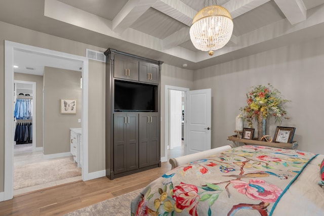 7501 Kirby Knowle Ct, Columbia, MO 65203 - bedroom featuring light wood finished floors, a chandelier, beamed ceiling, and a tray ceiling
