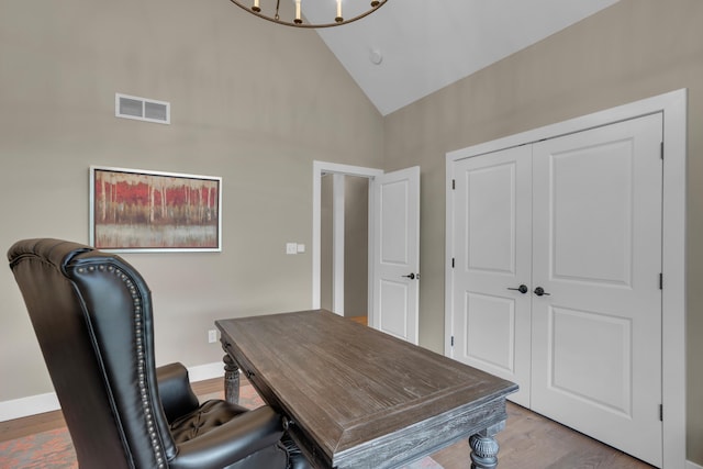 7501 Kirby Knowle Ct, Columbia, MO 65203 - home office featuring wood finished floors, high vaulted ceiling, and a chandelier