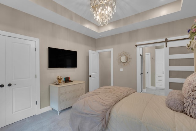 7501 Kirby Knowle Ct, Columbia, MO 65203 - bedroom featuring a barn door, light colored carpet, a tray ceiling, and a chandelier