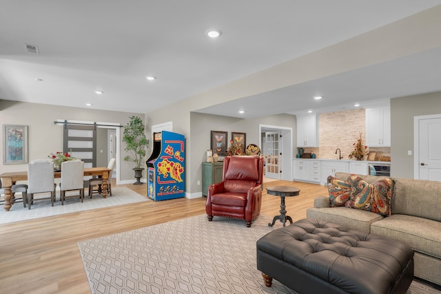 7501 Kirby Knowle Ct, Columbia, MO 65203 - living room with a barn door, light wood-type flooring, and recessed lighting