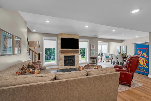 7501 Kirby Knowle Ct, Columbia, MO 65203 - living area with light wood-type flooring, a barn door, a fireplace, and recessed lighting