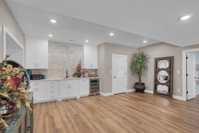 7501 Kirby Knowle Ct, Columbia, MO 65203 - kitchen with light wood-type flooring, light countertops, white cabinets, recessed lighting, and backsplash