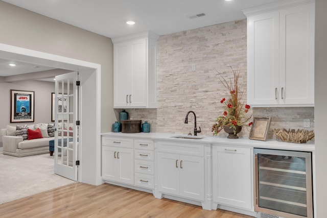 7501 Kirby Knowle Ct, Columbia, MO 65203 - indoor bar with beverage cooler, backsplash, light wood-style floors, and recessed lighting