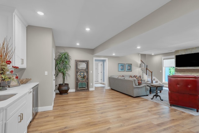 7501 Kirby Knowle Ct, Columbia, MO 65203 - living room featuring light wood-type flooring, stairs, recessed lighting, and beverage cooler