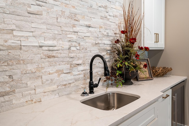 7501 Kirby Knowle Ct, Columbia, MO 65203 - kitchen view of white cabinetry, light stone countertops, beverage cooler, and tasteful backsplash