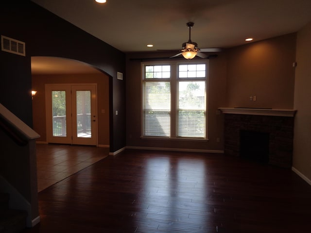 712 Anaconda Ct, Columbia, MO 65202 - unfurnished living room with arched walkways, a ceiling fan, wood finished floors, baseboards, and recessed lighting