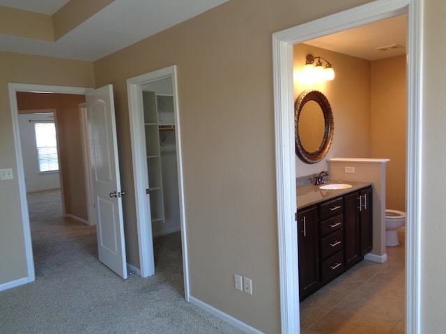 712 Anaconda Ct, Columbia, MO 65202 - bathroom featuring vanity, toilet, and baseboards