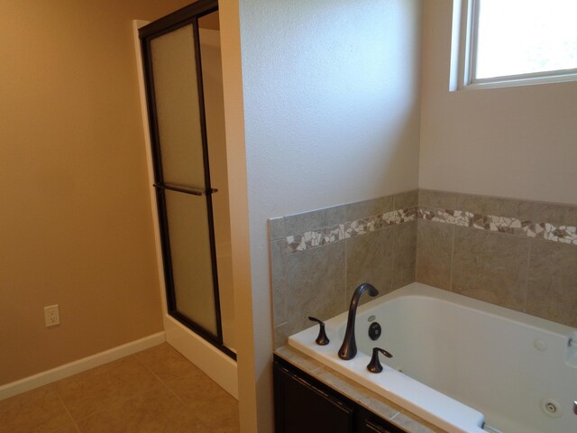 712 Anaconda Ct, Columbia, MO 65202 - bathroom with a stall shower, a tub with jets, tile patterned flooring, and baseboards