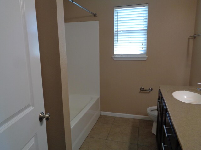 712 Anaconda Ct, Columbia, MO 65202 - bathroom with toilet, vanity, baseboards, tile patterned floors, and washtub / shower combination