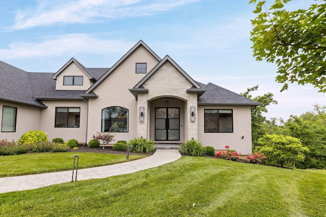 7305 Sella Ct, Columbia, MO 65203 - french country home with stucco siding, a front yard, and roof with shingles