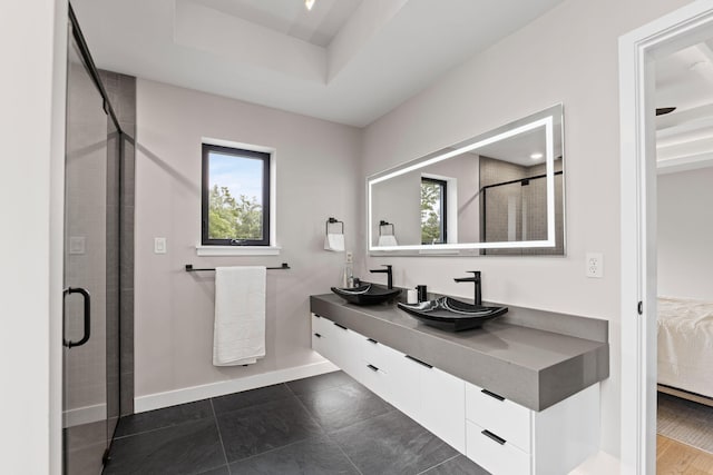 7305 Sella Ct, Columbia, MO 65203 - ensuite bathroom with double vanity, a stall shower, and baseboards