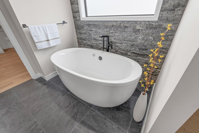 7305 Sella Ct, Columbia, MO 65203 - bathroom with a freestanding bath and baseboards