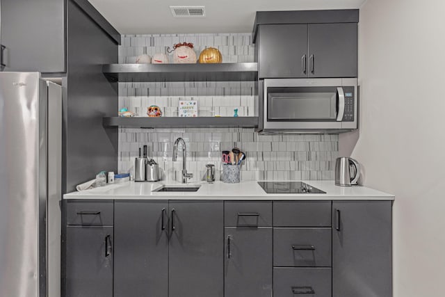 7305 Sella Ct, Columbia, MO 65203 - kitchen with gray cabinetry, appliances with stainless steel finishes, a sink, open shelves, and decorative backsplash