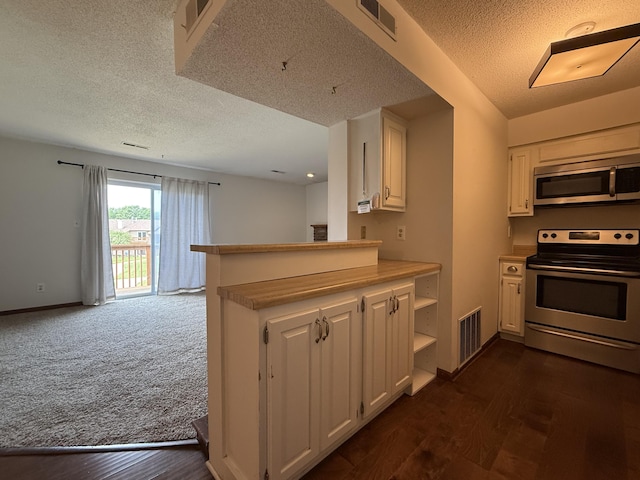 2009 N Waterfront Dr Unit G, Columbia, MO 65202 - kitchen with stainless steel appliances, white cabinets, a textured ceiling, baseboards, and dark wood-style floors