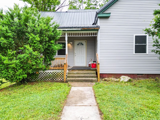 102 N Vine St, Fayette, MO 65248 - view of exterior entry with a porch, metal roof, a lawn, and crawl space