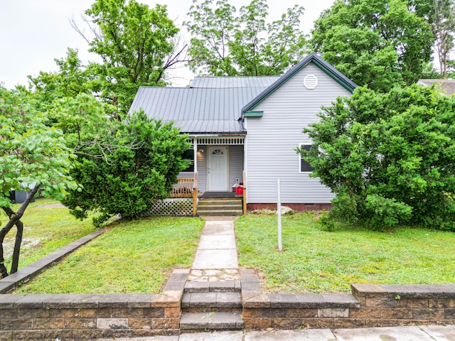 102 N Vine St, Fayette, MO 65248 - view of front facade with covered porch, a front yard, and metal roof