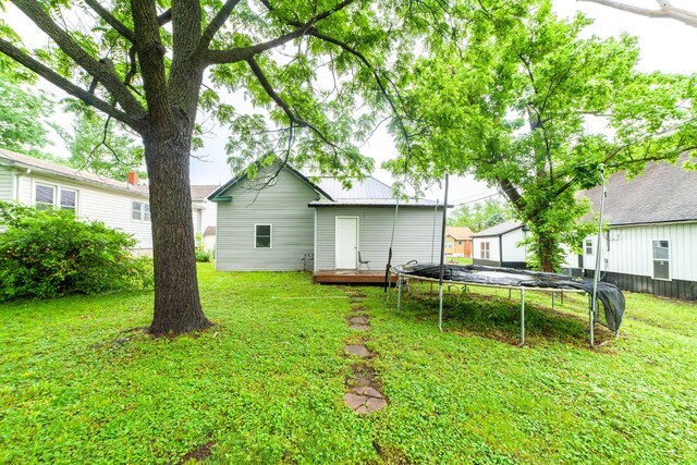 102 N Vine St, Fayette, MO 65248 - view of grassy yard featuring a trampoline