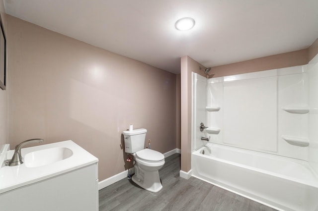 210 Oaklawn Ave, Fayette, MO 65248 - bathroom featuring wood finished floors, toilet, baseboards, shower / washtub combination, and vanity
