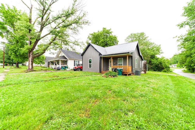 210 Oaklawn Ave, Fayette, MO 65248 - rear view of house featuring a porch, a lawn, metal roof, and central AC