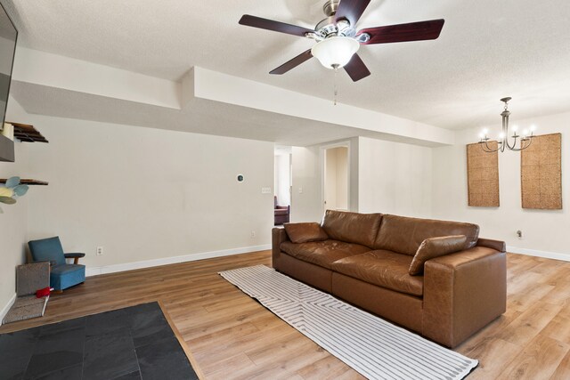 5700 Wilhite Rd, Columbia, MO 65202 - living area with light wood-style flooring, baseboards, a ceiling fan, and a chandelier