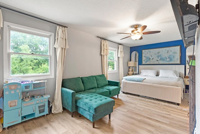 5700 Wilhite Rd, Columbia, MO 65202 - bedroom with wood finished floors, a textured ceiling, and ceiling fan