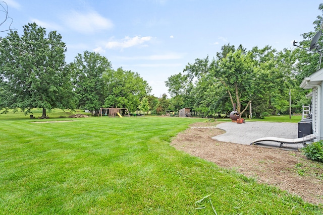 5700 Wilhite Rd, Columbia, MO 65202 - view of grassy yard with a playground and view of scattered trees