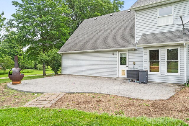 5700 Wilhite Rd, Columbia, MO 65202 - back of property featuring a patio area, a shingled roof, and a lawn