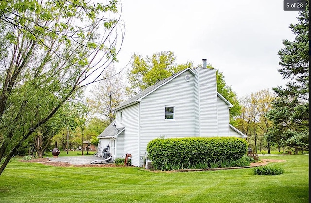 5700 Wilhite Rd, Columbia, MO 65202 - view of side of home with a chimney and a lawn