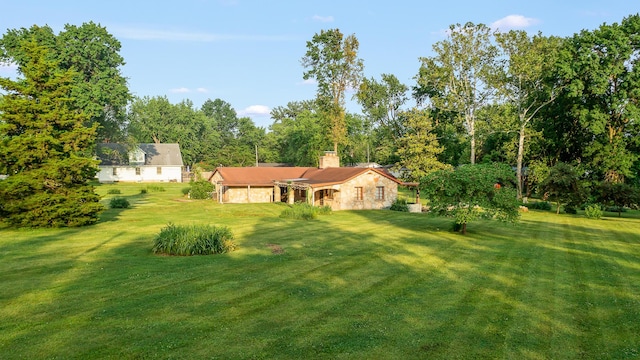 304 W Maple St, Auxvasse, MO 65231 - view of grassy yard with a garage
