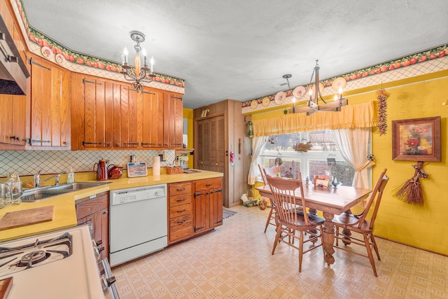 304 W Maple St, Auxvasse, MO 65231 - kitchen featuring a chandelier, white appliances, a sink, brown cabinetry, and light floors