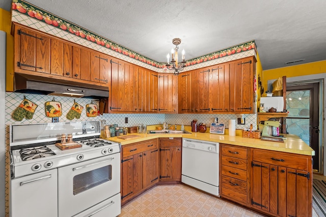 304 W Maple St, Auxvasse, MO 65231 - kitchen with white appliances, under cabinet range hood, a sink, and light countertops