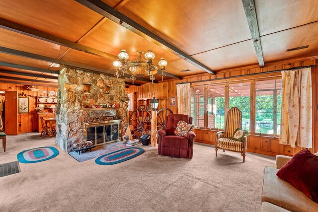 304 W Maple St, Auxvasse, MO 65231 - living area featuring wooden walls, carpet flooring, a chandelier, beamed ceiling, and a stone fireplace