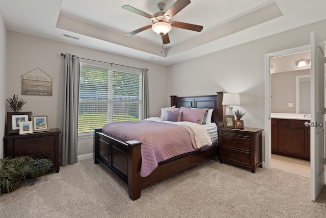 5817 Geyser Blvd, Columbia, MO 65202 - bedroom with a raised ceiling, light carpet, ensuite bathroom, ceiling fan, and baseboards