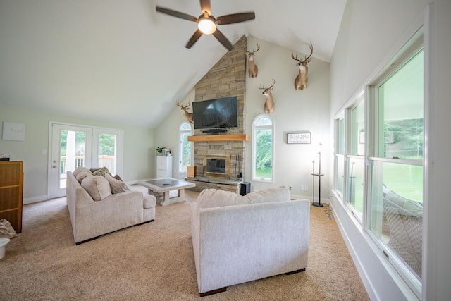 10060 E David Allen Rd, Columbia, MO 65201 - living area with a ceiling fan, carpet, a stone fireplace, plenty of natural light, and high vaulted ceiling