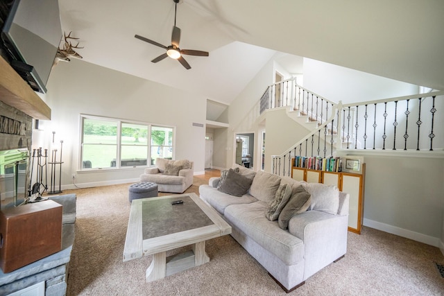 10060 E David Allen Rd, Columbia, MO 65201 - carpeted living area featuring high vaulted ceiling, ceiling fan, stairway, baseboards, and a fireplace