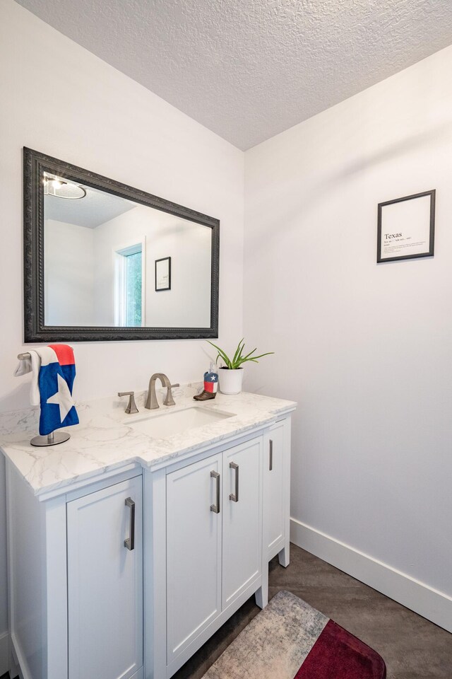 10060 E David Allen Rd, Columbia, MO 65201 - bathroom with vanity, a textured ceiling, and baseboards